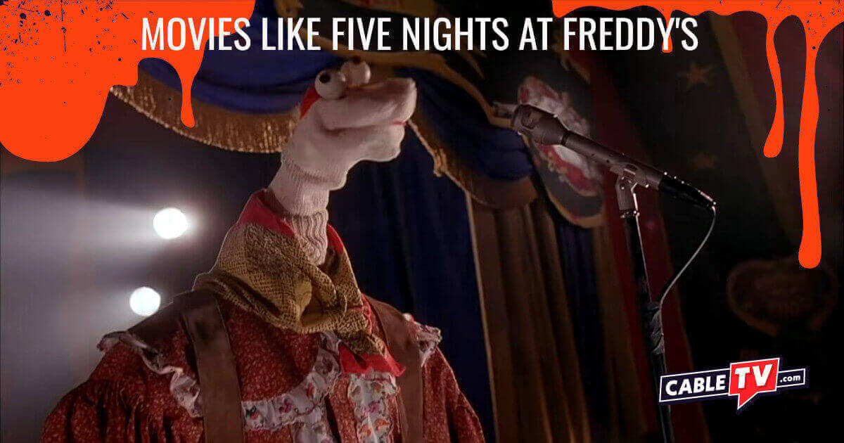 An anthropomorphic sock puppet performs onstage