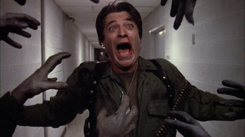 A soldier screams in terror as a horde of offscreen zombies reaches for him.