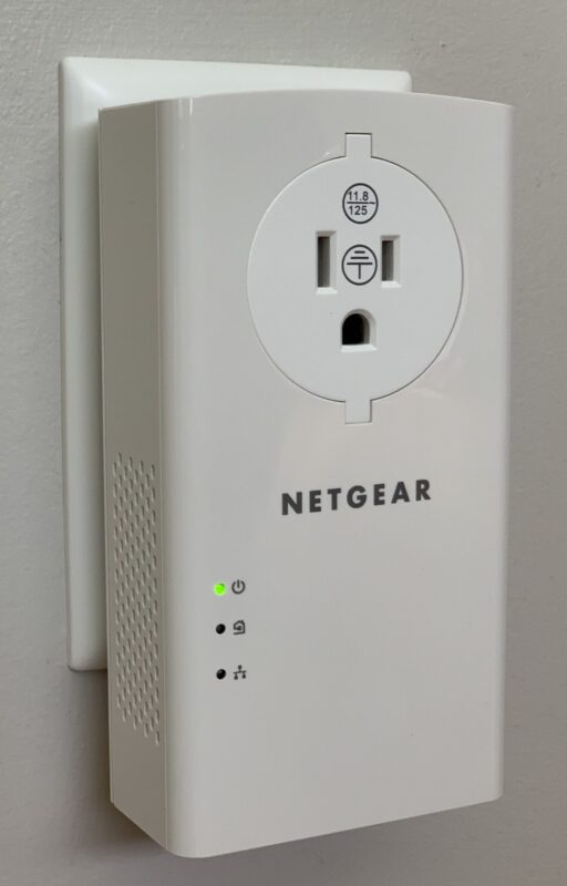 The Netgear PLP2000's front face has a power outlet and indicator LEDs.