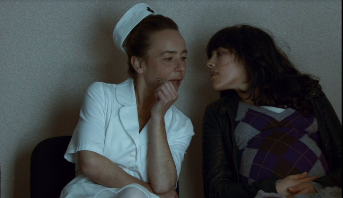 A nurse, smoking in the hospital waiting room, reacts to a pregnant woman's insult in Inside, one of the nastiest movies on Tubi.