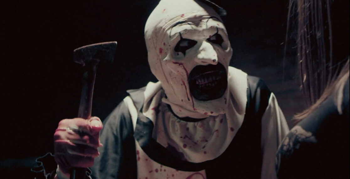 Image of a clown brandishing a hatchet—and baring a mouthful of bloody teeth.