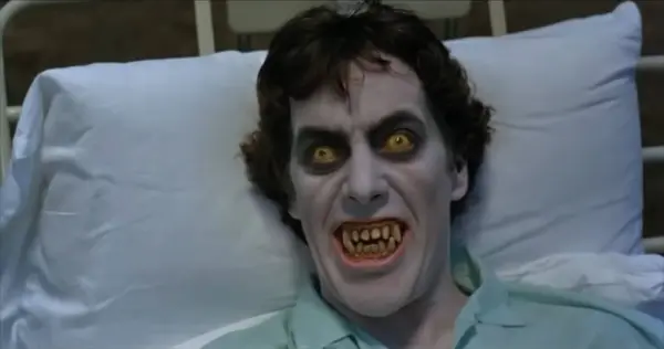 A man with a demonic face hisses from a hospital bed in the woods. A scene frrom An American Werewolf in London, one of several free horror movies to stream right now.