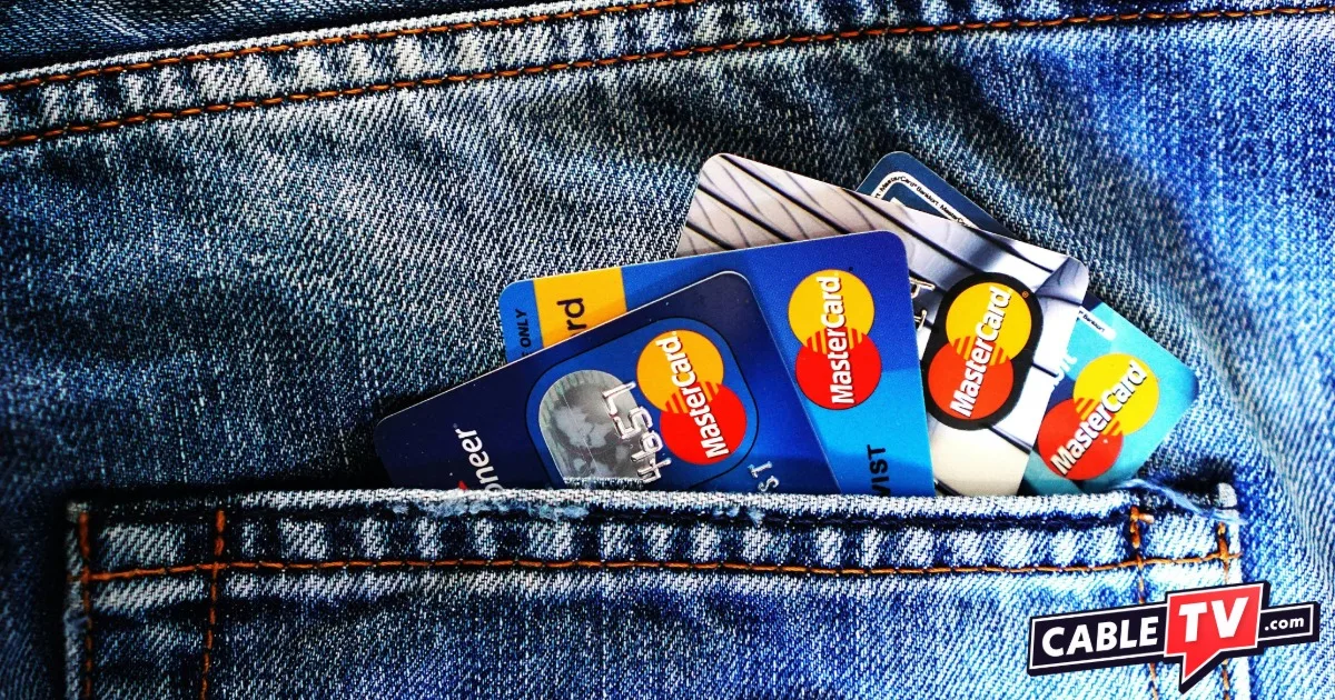 Image of denim back pocket with a display of Mastercards poking out